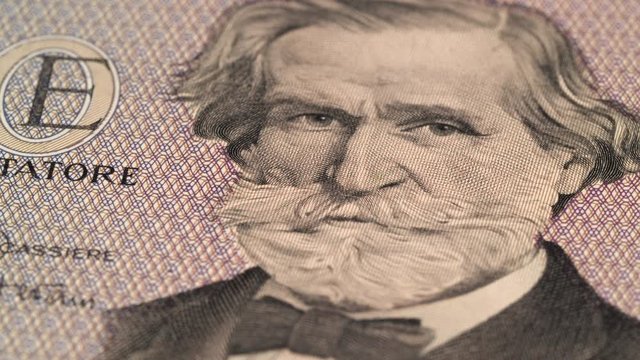 Giuseppe Verdi portrait on Italy 1000 lira (1977) banknote rotating. Famous Italian composer. Low angle, macro. 4K, 422 10 bit