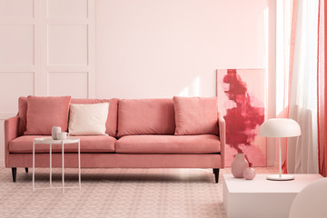 Stylish abstract paining on the wall of trendy living room interior