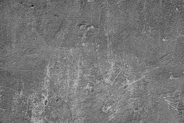 Texture of a concrete wall with cracks and scratches which can be used as a background