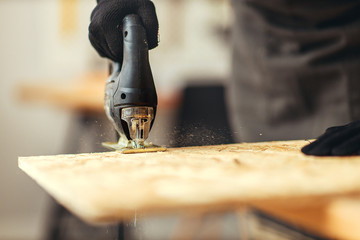 woodwork carpenter saws  Board with jigsaw close up.
