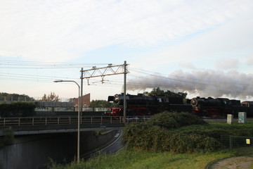 Fototapeta na wymiar Two old steam locomotives running on the track at Nieuwerkerk aan den Ijssel