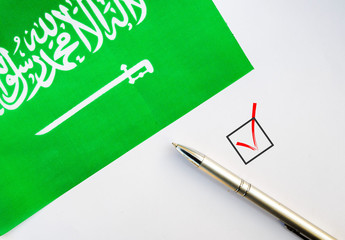 Pencil, Flag of Saudi Arabia and check mark on paper sheet