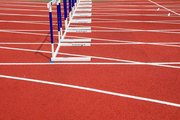 Hurdle bracket on red plastic runway