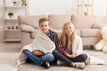 Cute Brother And Sister Covered With Blanket Sitting On Floor