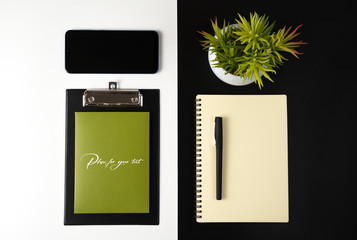 Desktop view from the top with stationery, phone, Notepad, flower, business concept, environmental protection.
