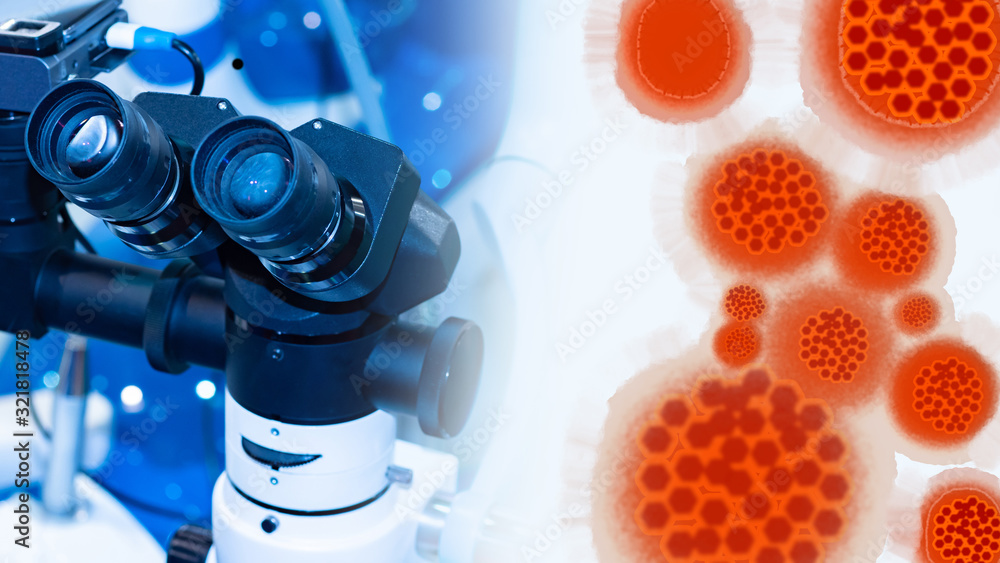Poster enlarged coronavirus molecules on the background of an operating microscope. the causative agents of