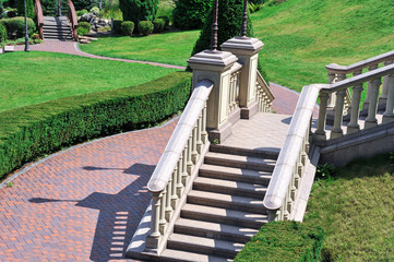 A beautiful staircase is buried in summer greenery. Elements of architecture. Stylish landscape
