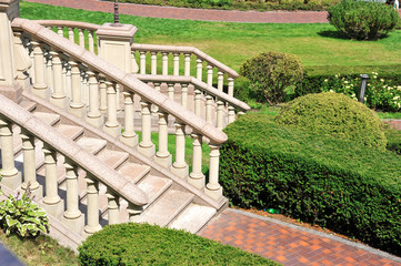 A beautiful staircase is buried in summer greenery. Elements of architecture. Stylish landscape