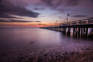 Fototapeta na wymiar Amazing sunrise over wooden pier in Gdynia Orlowo.