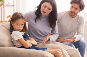 Annoyed Parents Scolding Their Little Daughter For Her Behaviour At Home