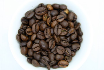 a handful of coffee beans on a white background