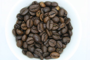 a handful of coffee beans on a white background