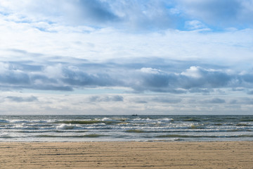 Beautiful winter Baltic sea on a windy day. In a distant fishing boat.