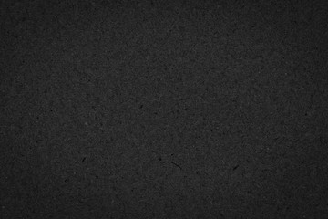Texture of black gift rough paper with fibers. Dark background for design, template, greeting card, website backdrop.