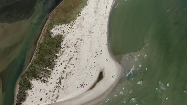 Aerial shot of a white sandy Black Sea shore with green waters in summer  