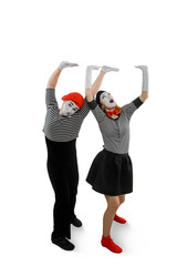 Two mimes posing on white background. Man and woman performing a pantomime