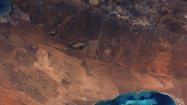 Aerial satellite Australian Ningaloo marine park, coastline and coral reef ecosystem on Indian ocean, sunrise animation. Images furnished by Nasa