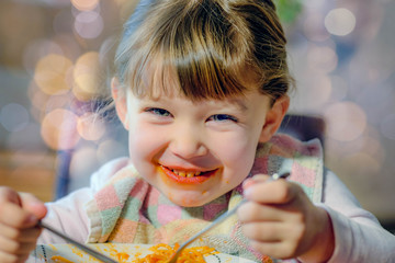 cute little girl eating spaghetti bolognese