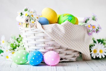 Happy Easter. Congratulatory easter background. Easter eggs and flowers. Background with copy space. Selective focus.
