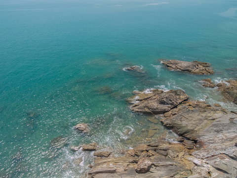 Top view of many rocks in blue-green sea background, Laem Tanod (Tanod Cape), Mu Ko Lanta National Park, Lanta island, Krabi, southern of Thailand.