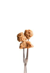 Soymeat on fork, isolated on white backgrounf