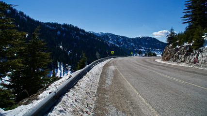 snowy mountain roads, blue sky and clouds