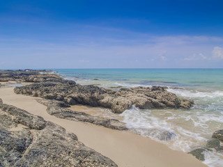 view seaside of many arch rocks and wave on white sand beach with blue-green sea and blue sky background, Ba Kan Tiang Bay, Ko Lanta island, Krabi, southern of Thailand.