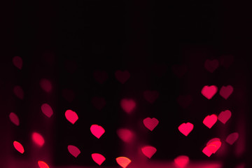 Abstract blur defocused background black, pink lights highlights, bokeh hearts, soft focus