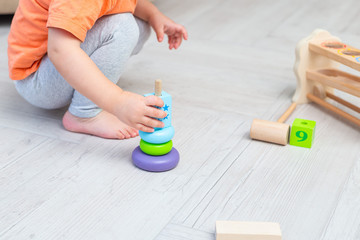 Obraz na płótnie Canvas Education wooden toys. A child plays with wooden toys
