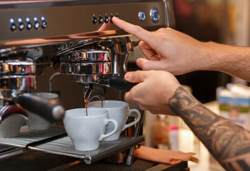 Barista Preparing Espresso Using Coffee-Machine In Coffee Shop, Closeup, Cropped