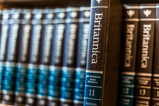 Encyclopedia Britannica volumes on a shelf in a public library