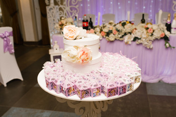 Wedding candy boxes and a collection box on the gift table. Wedding decor