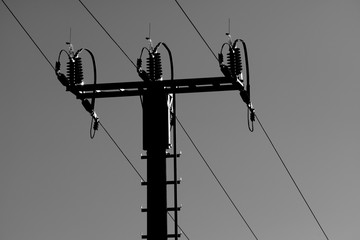 High voltage power line tower on sky background.