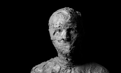 dramatic black and white portrait, shapeless face formed from torn pieces of clay