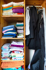 Garderobe Wardrobe with many different clothes and shirts