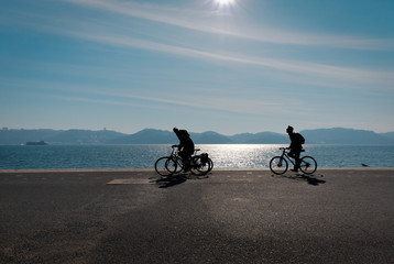 Fototapeta premium Walking along the banks of the Tagus River on a bicycle. The area of Lisbon is Belem. Portugal.