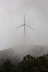 wind turbine against clouds and sky