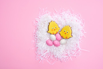 Glazed cookies and eggs in white nest.