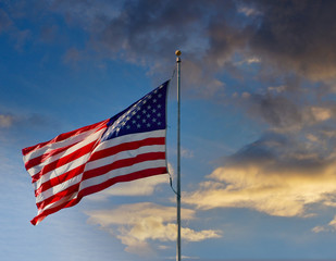 An American Flag blowing in a light wind against a blue sky