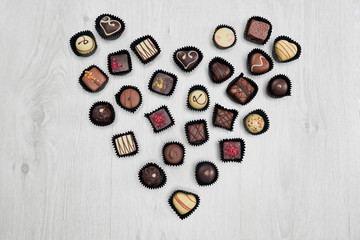 Assorted chocolate sweets in shape of heart.