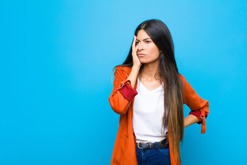 young pretty latin woman feeling bored, frustrated and sleepy after a tiresome, dull and tedious...