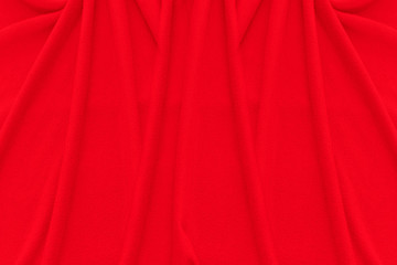 Red fabric texture background. Abstract cloth backdrop with soft waves.