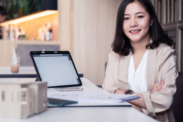 Fototapeta premium Architect or interior designer working with material sample board in showroom. Business of Real estate, home decoration .Creative people workplace. young designer woman working at office desk.