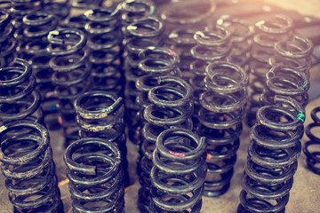 Many  old automotive suspension coil spring. Black springs automotive. Car coil springs.