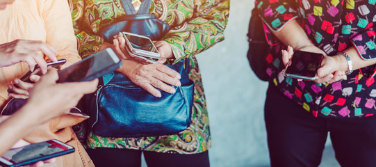 Elderly women learn how to use applications related to language translation from young men. While traveling abroad at the airport.