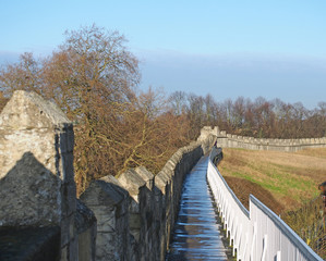 Fototapeta premium a view along the pedestrian walkway on historic medieval city walls in york