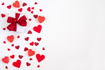 Valentines day composition. Greeting card with confetti hearts, candles and a gift on a white background. Valentines day concept.