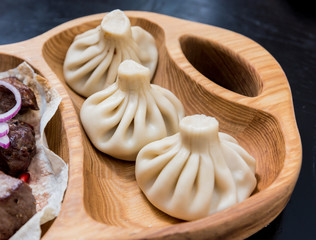 Georgian cuisine food. Grilled meat with khinkali. Georgian restaurant.
