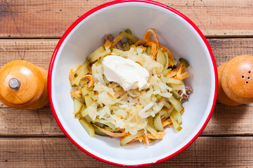 Step-by-step salad preparation with boiled beef and egg pancakes, step 5 - adding salt, pepper and mayonnaise to the salad, top view, horizontal