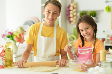 Portrait of brother and sister baking together